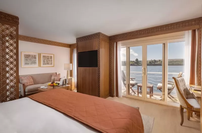 Elegant cabin aboard Steigenberger Senator Nile Cruise – cozy bedding and large windows facing the Nile